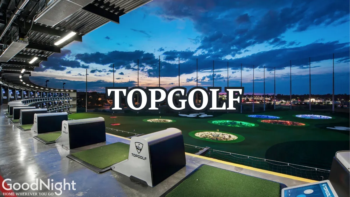 The illuminated bays and targets at Topgolf are set against a city skyline, inviting groups to compete, relax, and socialize in an energetic, open-air environment. The setting exudes excitement and possibility for friendly gatherings.