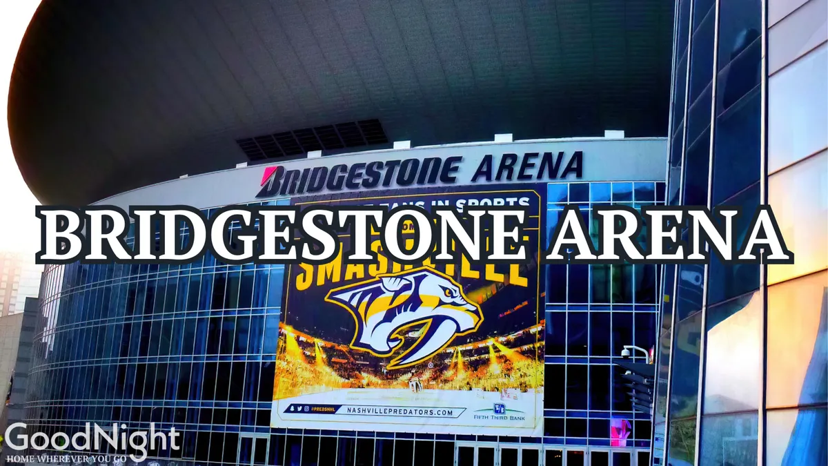 The iconic exterior of Bridgestone Arena, complete with a large Nashville Predators banner and modern architecture. The buzz of the venue highlights the vibrancy of local events and the ease of accessing major city attractions from the property.